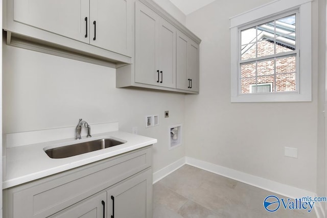 laundry room with cabinets, washer hookup, hookup for an electric dryer, and sink