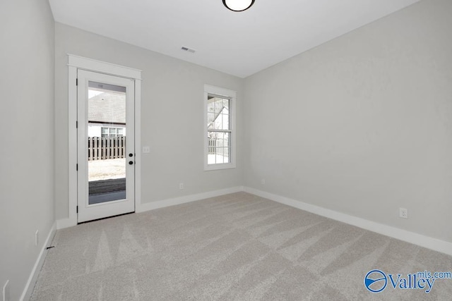 unfurnished room with light colored carpet