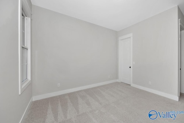 unfurnished bedroom featuring light colored carpet