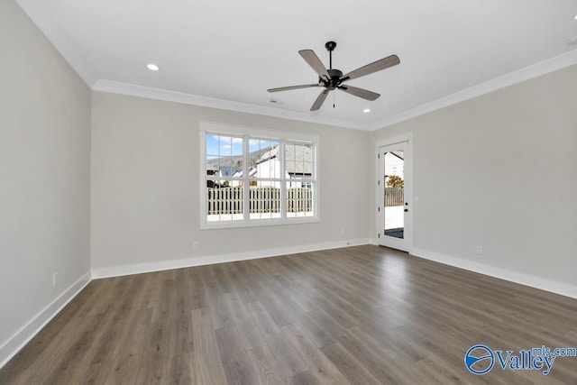 spare room with dark hardwood / wood-style flooring, plenty of natural light, ornamental molding, and ceiling fan