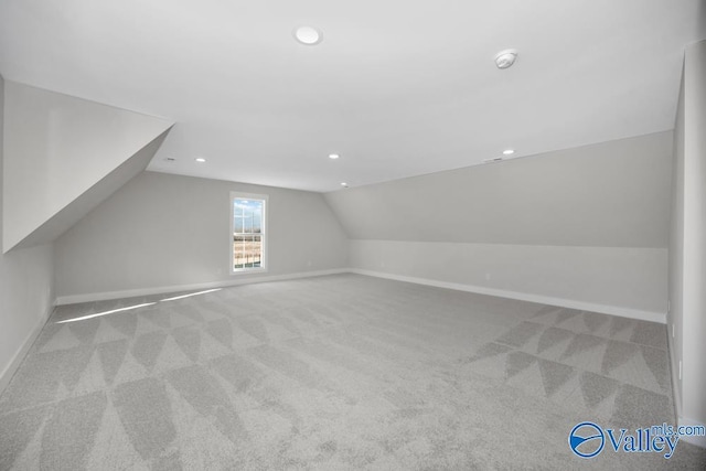 additional living space with light carpet and lofted ceiling