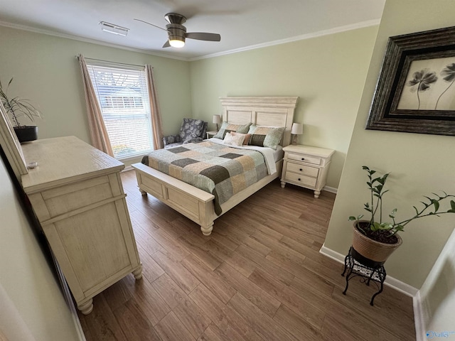 bedroom with dark wood-style flooring, visible vents, ornamental molding, ceiling fan, and baseboards