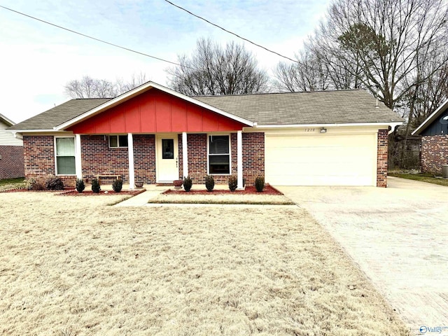 ranch-style house featuring driveway, a garage, board and batten siding, and brick siding