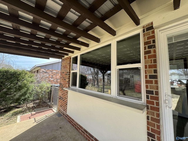 view of property exterior with cooling unit and brick siding