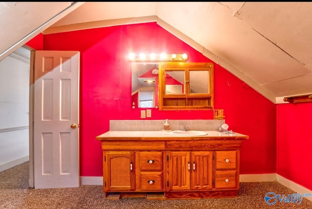 bathroom featuring vanity and vaulted ceiling