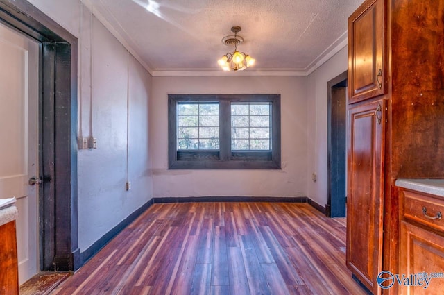 unfurnished dining area with a notable chandelier, dark hardwood / wood-style flooring, ornamental molding, and a textured ceiling