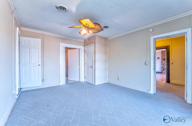 unfurnished bedroom featuring carpet floors, ceiling fan, and ornamental molding