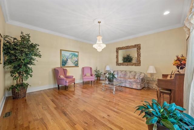 sitting room with baseboards, visible vents, wood finished floors, and ornamental molding