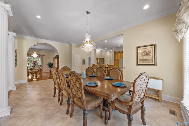 dining space with arched walkways, light tile patterned floors, visible vents, and crown molding