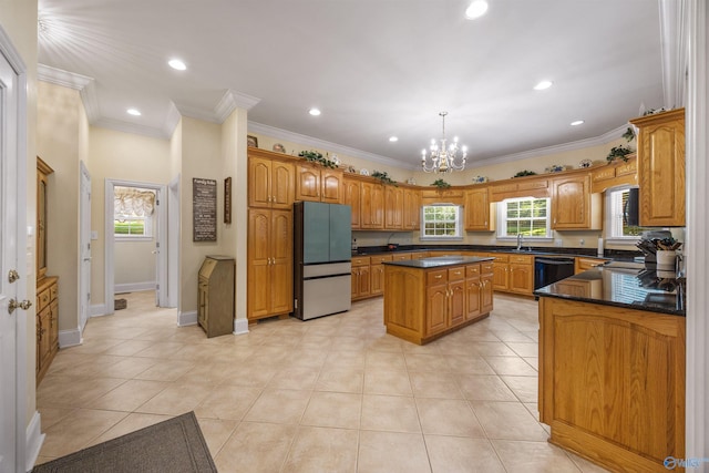 kitchen featuring a kitchen island, freestanding refrigerator, dishwasher, dark countertops, and decorative light fixtures