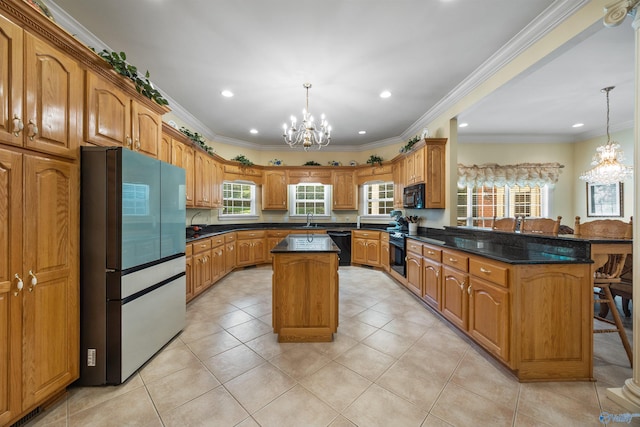 kitchen with pendant lighting, a notable chandelier, a kitchen island, a sink, and black appliances