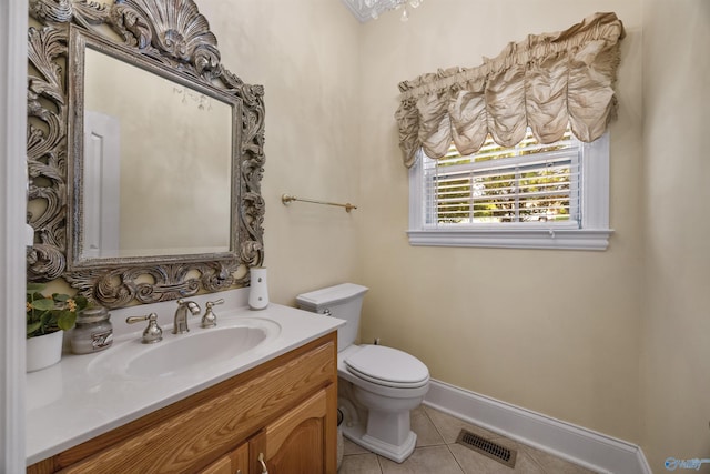 bathroom featuring visible vents, baseboards, toilet, tile patterned flooring, and vanity