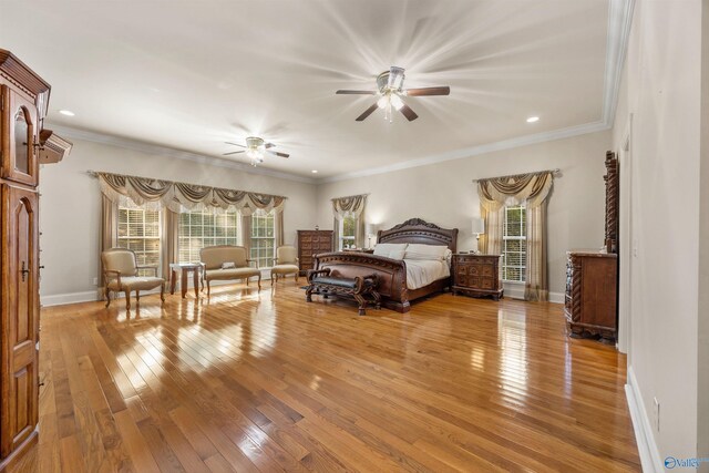 bedroom featuring crown molding, light wood-style flooring, and baseboards