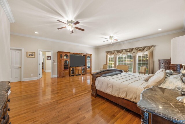 bedroom featuring light wood-style flooring, ornamental molding, and baseboards