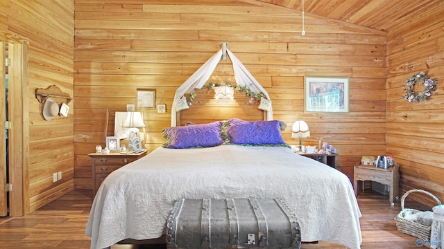 bedroom with lofted ceiling, dark wood-type flooring, and wooden walls