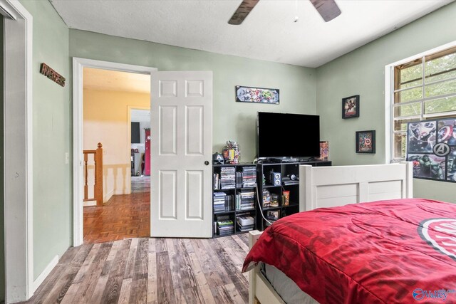 bedroom with a textured ceiling and ceiling fan