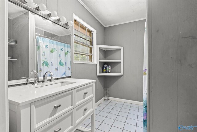 bathroom with ornamental molding, vanity, and tile patterned flooring