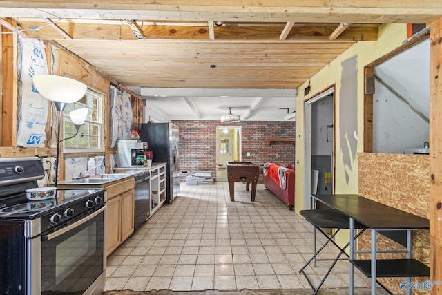 kitchen featuring electric stove, light brown cabinetry, brick wall, black dishwasher, and light tile patterned floors