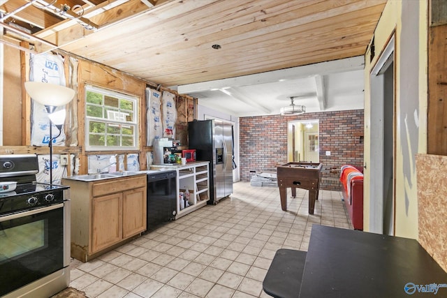 kitchen featuring brick wall, black dishwasher, stove, stainless steel fridge, and light tile patterned floors