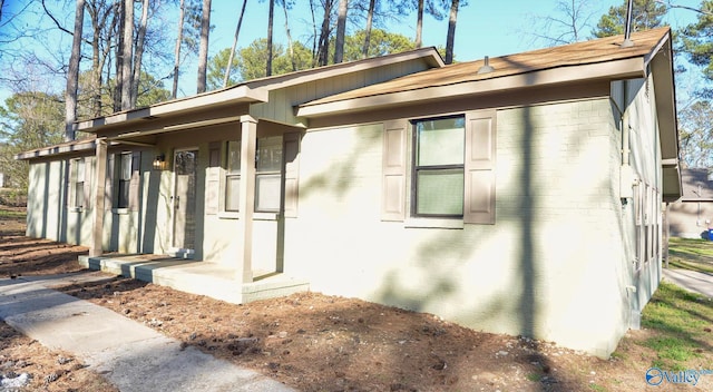 view of property exterior with brick siding