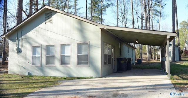 exterior space featuring concrete driveway and a carport