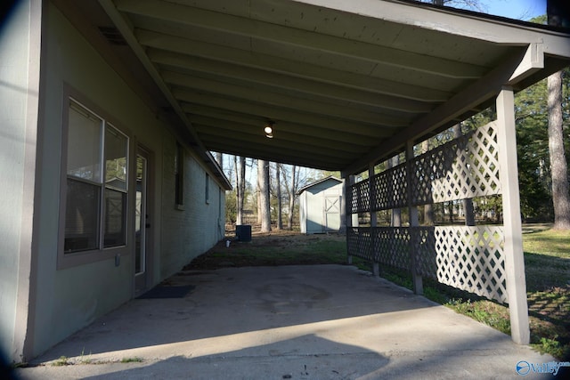 view of patio / terrace featuring visible vents, an attached carport, and central AC