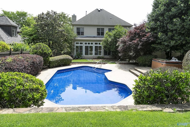 outdoor pool with a patio area