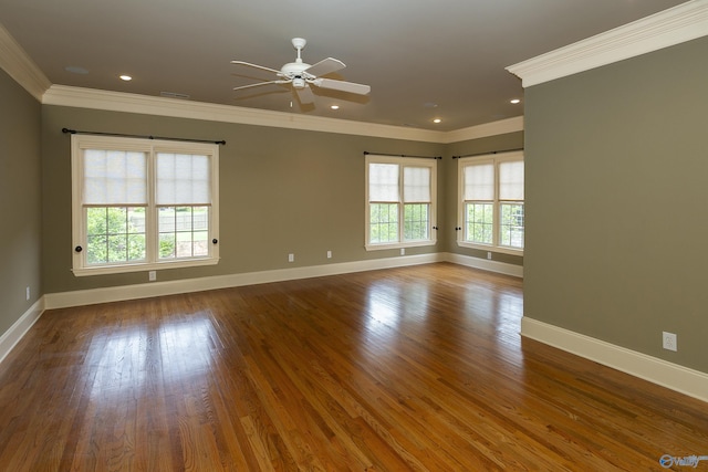 empty room with recessed lighting, wood finished floors, visible vents, baseboards, and ornamental molding