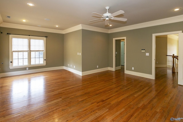 empty room with recessed lighting, crown molding, baseboards, and wood finished floors