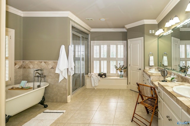 bathroom featuring vanity, crown molding, a bathing tub, and tile patterned floors