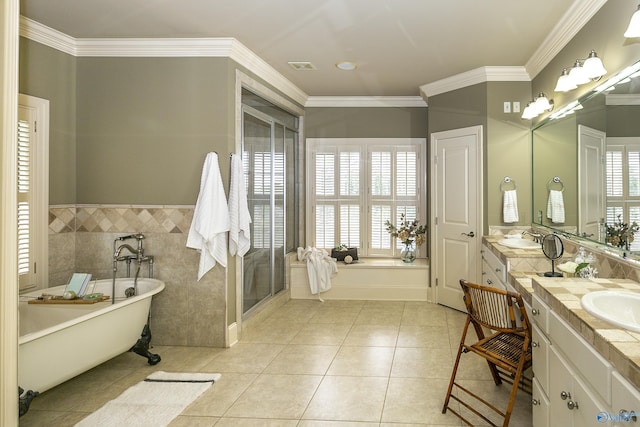 bathroom featuring tile walls, vanity, a soaking tub, tile patterned floors, and plenty of natural light