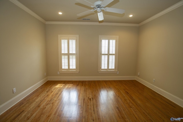 unfurnished room featuring ceiling fan, ornamental molding, wood finished floors, and baseboards