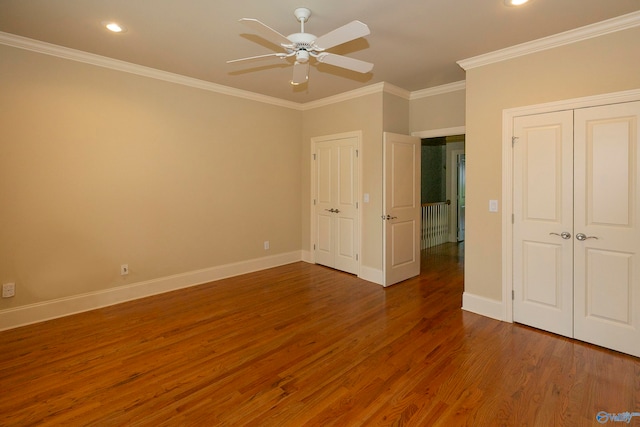 unfurnished bedroom featuring ceiling fan, hardwood / wood-style flooring, and ornamental molding