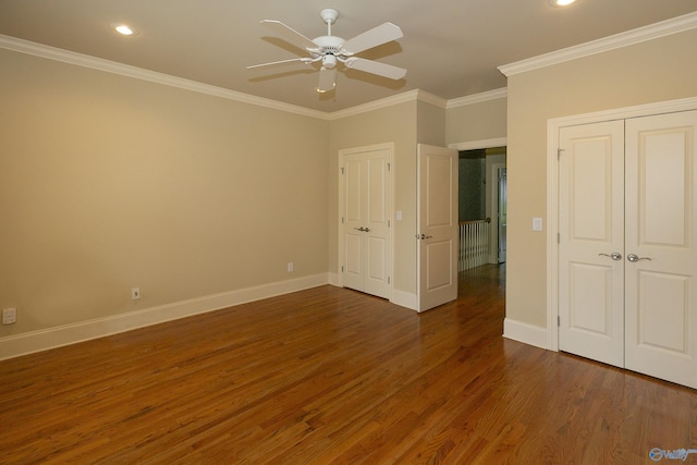 unfurnished bedroom featuring recessed lighting, ornamental molding, ceiling fan, wood finished floors, and baseboards