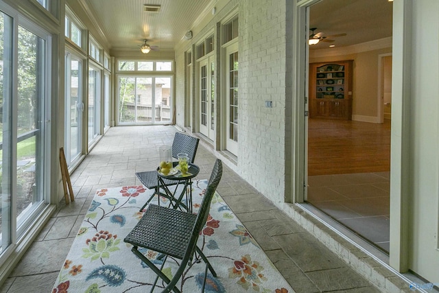 sunroom with ceiling fan and visible vents