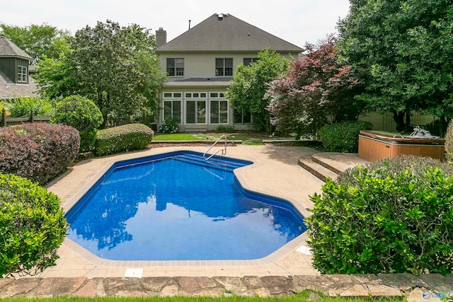 view of swimming pool with a patio