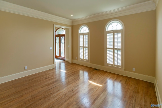 unfurnished room with light hardwood / wood-style flooring and crown molding