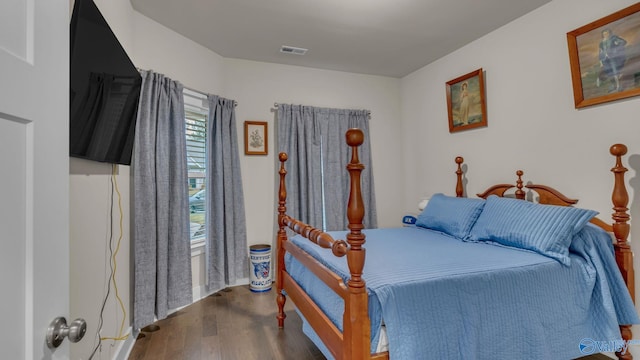 bedroom with visible vents and wood finished floors