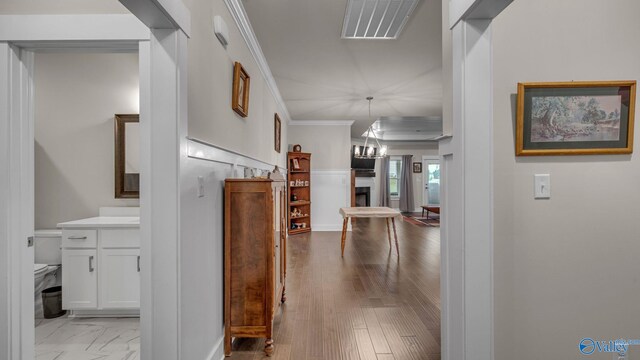 corridor with visible vents and ornamental molding
