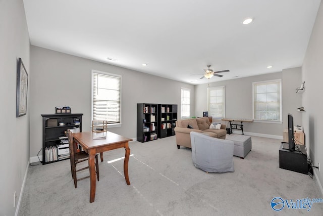 carpeted living room with ceiling fan