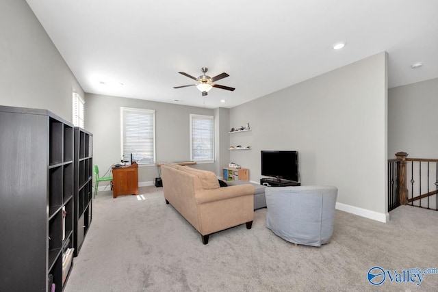 carpeted living room featuring plenty of natural light and ceiling fan