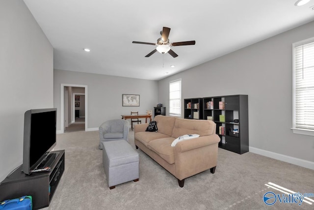 carpeted living room featuring ceiling fan