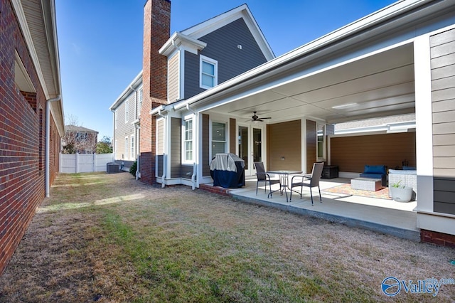 back of house with a lawn, ceiling fan, central AC, an outdoor hangout area, and a patio area