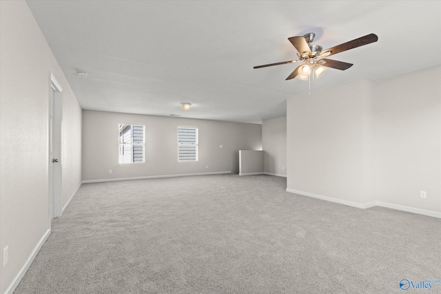 carpeted spare room featuring ceiling fan