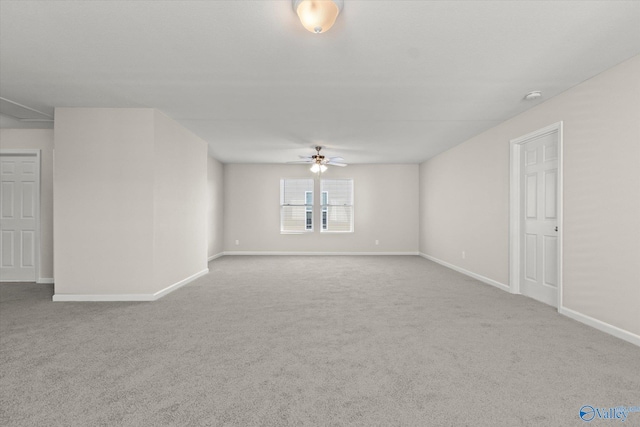 unfurnished room with light colored carpet and ceiling fan