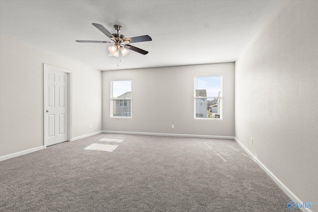 unfurnished room with ceiling fan and carpet