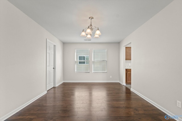 unfurnished dining area with a notable chandelier and dark hardwood / wood-style floors