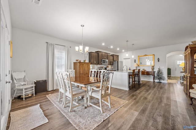 165 Saddle St, New Market, AL 35761 - dining room with arched walkways, dark wood-style flooring, a chandelier, and recessed lighting