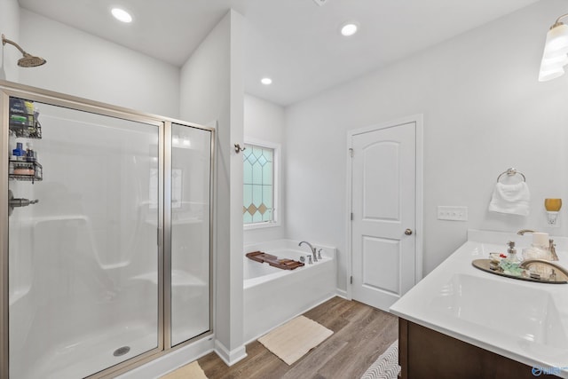 165 Saddle St, New Market, AL 35761 - bathroom with a shower stall, wood finished floors, a garden tub, and double vanity