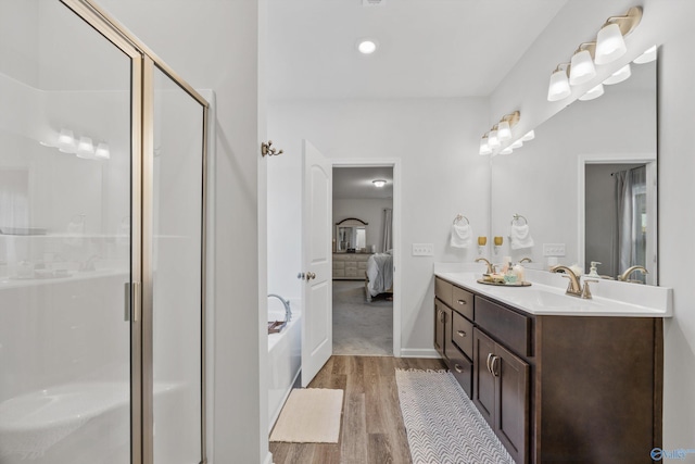 165 Saddle St, New Market, AL 35761 - ensuite bathroom featuring wood finished floors, double vanity, a shower stall, and a bath